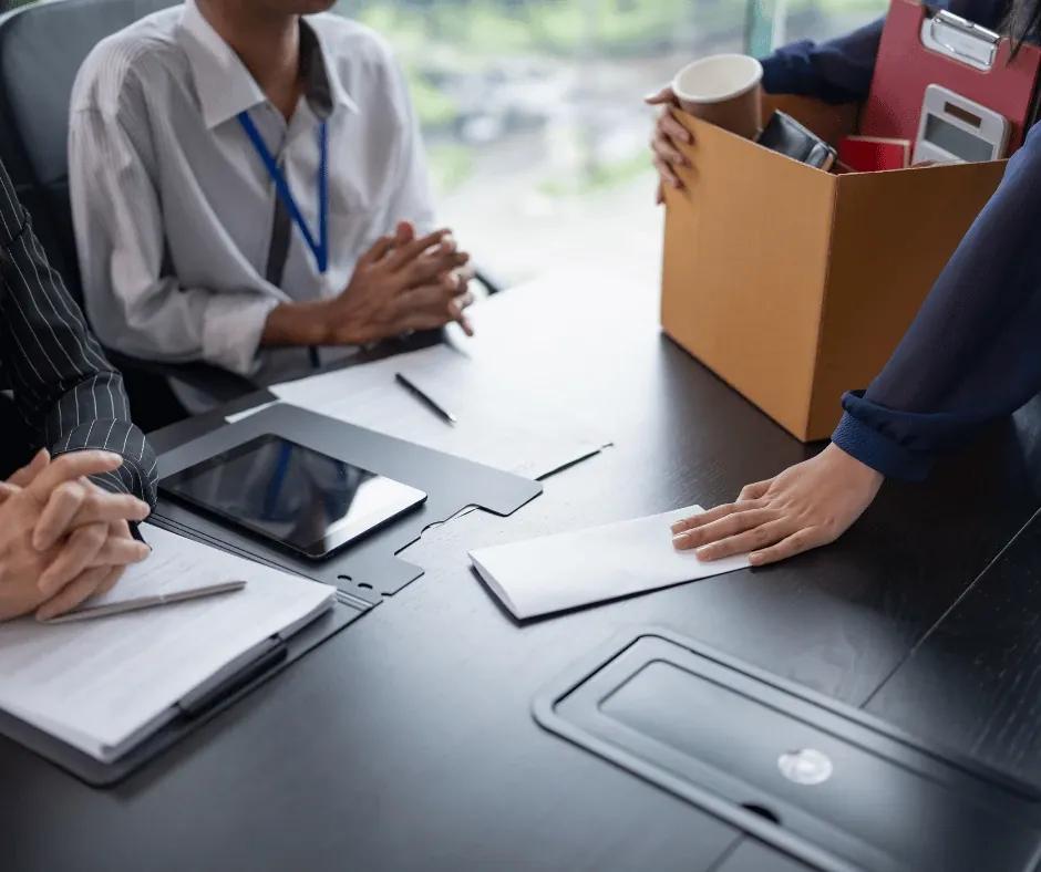 Manager coaching a team member while reviewing competency matrices.